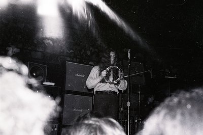 Vintage black-and-white photo of a musician playing a Marshall stack amplifier, likely a **Jimi Hendrix** tribute or 1960s-70...