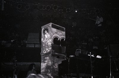 Vintage neon sign featuring a stylized woman in a flowing dress, illuminated against a dark night backdrop. Art deco-inspired...