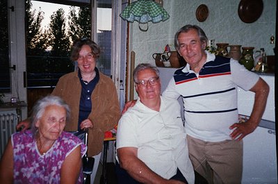 Four seniors pose indoors, likely mid-1980s to early 1990s. Woman on left wears floral-patterned blouse; others in casual 80s...