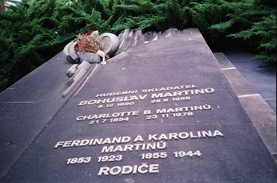 Monumental gravestone in a cemetery with engraved names and dates in Czech/Slovak script. Bohuslav Martinů (composer, 1890–19...