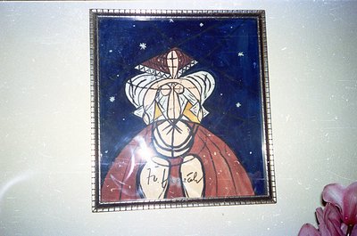 Vintage ceramic tile mural featuring a stylized female figure in a headdress with geometric patterns, set against a dark blue...