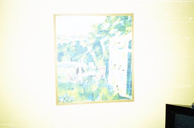 Vintage abstract landscape painting in muted greens and blues, framed in gold. Depicts stylized trees and rolling hills, evok...