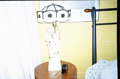 Vintage bedside lamp with Art Deco-inspired ceramic base featuring a female figure in flowing dress, paired with a decorative...