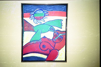 Vibrant abstract mural featuring bold geometric forms: a red sunburst, green abstract bird, and blue/white sky. Bold outlines...