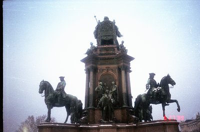 Equestrian monument featuring three mounted figures flanking a central pedestal with ornate reliefs, likely from the late 19t...