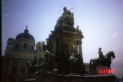 Equestrian statue and grand equestrian monument in dusk lighting, featuring a central figure atop a horse with surrounding fi...