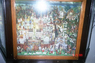 Vintage painted scene depicting a bustling medieval European town with ornate architecture, including spires, domes, and a ce...