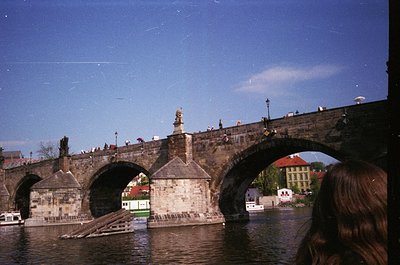 Vintage photograph of the historic **Charles Bridge (Karlův most)** in Prague, Czech Republic, featuring Gothic stone arches ...