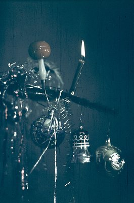 Vintage metallic chandelier with ornate, industrial-style design—fluted globes, candle-like bulbs, and exposed wiring. Likely...