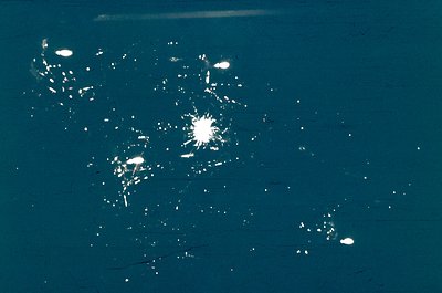 Aerial nighttime view of urban lights forming geometric patterns. Likely a satellite or drone capture showing city infrastruc...