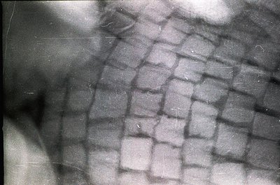 Close-up of a **herringbone-patterned stone wall**, likely part of historic masonry. The interlocking V-shaped cuts suggest 1...