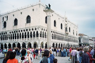 Venetian Gothic architecture of the Doge’s Palace dominates Piazza San Marco, featuring intricate white marble facades with G...