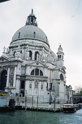 Baroque-style **Basilica di Santa Maria della Salute** in Venice, Italy, with its iconic dome and intricate façade overlookin...