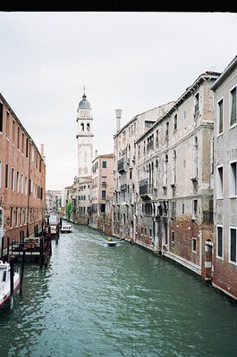 Classic Venetian canal scene with historic architecture. Symmetrical row of 16th–18th century buildings flanking a narrow wat...