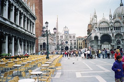 Venetian Piazza scene with Renaissance/Gothic architecture: ornate façade of Doge’s Palace () and St. Mark’s Campanile () in ...