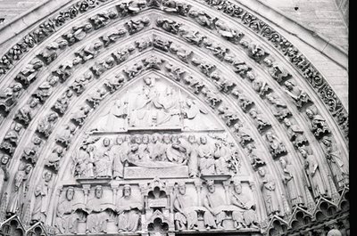 Gothic stone portal featuring intricate high-relief sculptures depicting biblical scenes, likely from a 13th–14th century Eur...