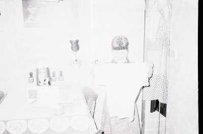 Vintage black-and-white interior shot of a minimalist 1960s–70s living space. Clean lines, geometric furniture, and a single ...