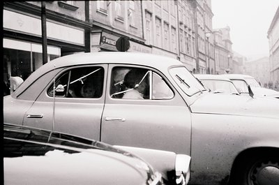 Classic mid-century taxi with "POLICE" sign on roof, likely a vintage Škoda or similar Eastern Bloc model. Urban street scene...