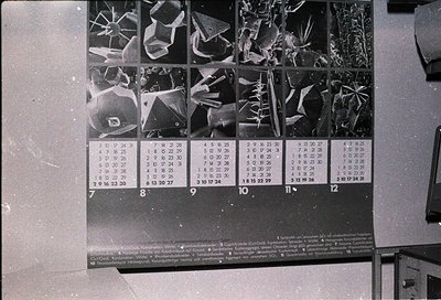 Vintage scientific crystal X-ray diffraction patterns arranged in a 3x4 grid on a blackboard, labeled with numerical codes (1...
