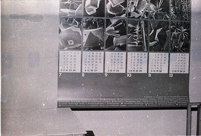 Vintage 1960s–1970s perforated calendar featuring black-and-white aerial photography of snow-covered alpine terrain. Grid lay...