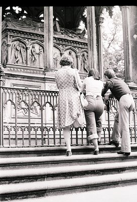Black-and-white photo of three individuals ascending ornate stone steps in a historic European setting, likely 1960s–1970s. I...