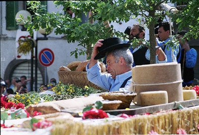 Vintage street market scene featuring a man in traditional attire adjusting a wide-brimmed hat while holding a woven basket. ...