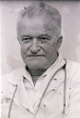 Portrait of an elderly man in a vintage stethoscope draped over his shoulders, suggesting a medical profession. The grainy, m...