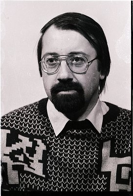 Portrait of a man in a patterned sweater, likely from the 1970s–1980s. Geometric, geometric-textured knit with bold black-and...