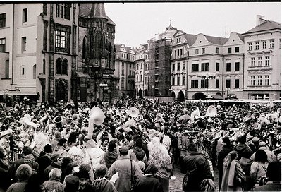 Historic street festival in Prague’s Old Town Square, featuring Baroque/Renaissance architecture with ornate facades and arch...