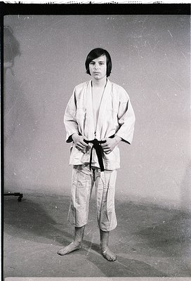 Portrait of an individual in a traditional judogi (karate/judo uniform) with a black belt, likely mid-20th century. Plain ind...