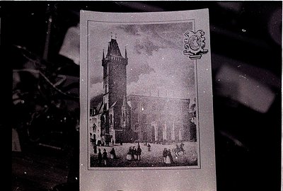 Vintage postcard featuring a Gothic-style tower with crenellated parapets and a clock, likely part of a European cathedral or...
