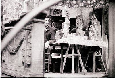 Artisans crafting intricate plaster sculptures in a workshop, likely 1950s–1970s. Visible tools, unfinished religious figures...