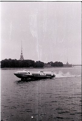 1960s hydrofoil ferry crossing Neva River, St. Petersburg, USSR. Iconic Peterhof Palace and Peter and Paul Fortress spires in...