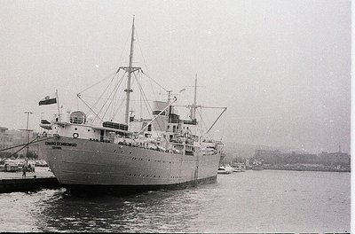 Mid-20th century passenger ship "Eduardo de Medina" docked at port, likely Bulgaria’s Black Sea coast. Noted for its sleek hu...
