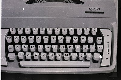Vintage electric typewriter with QWERTY layout, featuring Cyrillic characters and numeric keypad. Model -1347 suggests Easter...