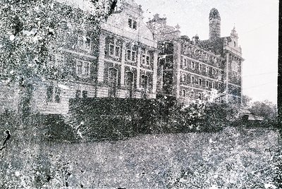 Grand neoclassical building with symmetrical façade, tall windows, and central tower—likely a historic hotel or institutional...