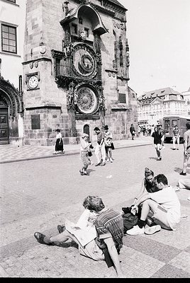 Mid-20th century black-and-white shot of Prague’s Astronomical Clock tower () with medieval Gothic architecture (). Tourists ...