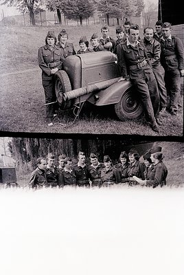 Military personnel in 1940s-era uniforms pose with a vintage motorcycle in an outdoor setting. Uniforms feature peaked caps, ...