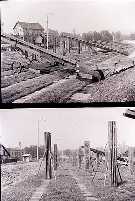 Mid-20th century railway construction site with wooden trestle bridges and track-laying equipment. Top: Conveyor-like rail ca...