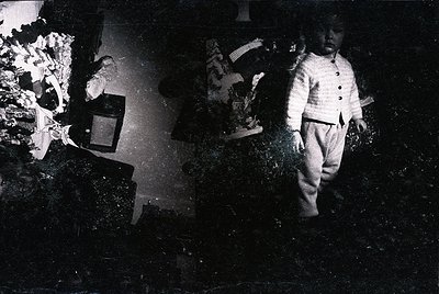 Vintage split-image portrait of two children in early 20th-century attire, one seated at a wooden table with a typewriter, th...