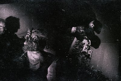 Vintage black-and-white photo of two women engaged in a dance or ritual, likely from the 1960s–1970s. One woman wears a patte...