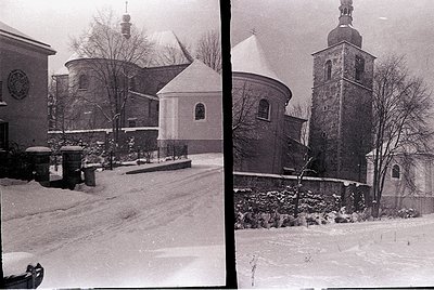 Historic Orthodox church complex blanketed in snow, featuring a domed chapel and bell tower with cross. Snow-covered courtyar...