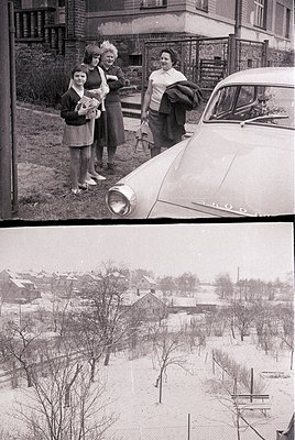 Vintage black-and-white photo of three women posing beside a classic car (likely a Škoda) in a residential neighborhood. Snow...