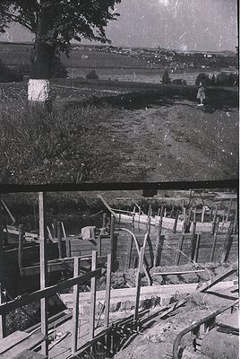 Vintage black-and-white split image: Top shows a child playing near a rural embankment with distant urban skyline, suggesting...