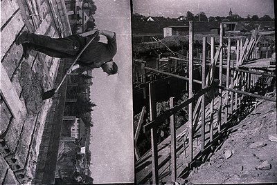 Mid-century construction worker mid-climb on precarious wooden scaffolding beside unfinished concrete walls, likely 1950s–196...