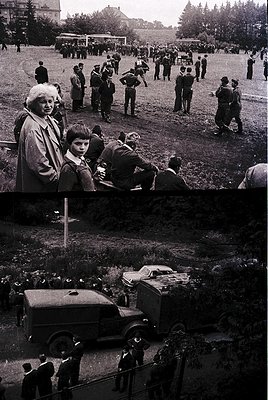 Mid-20th century outdoor gathering in a grassy field with vintage cars and uniformed individuals. Crowd includes adults and c...