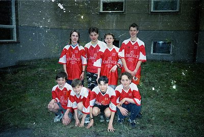 Vintage team photo of **ZS Treznice** soccer players, 1990s. Seven young men in red-and-white striped jerseys pose outdoors a...