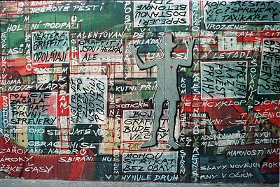 Vibrant graffiti mural featuring bold, layered text in Cyrillic script with a mix of red, green, and white colors. Central si...