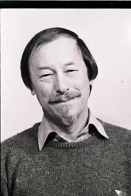 Portrait of a man with a mustache and beard, wearing a collared sweater. Classic mid-20th century style, likely or . Neutral ...