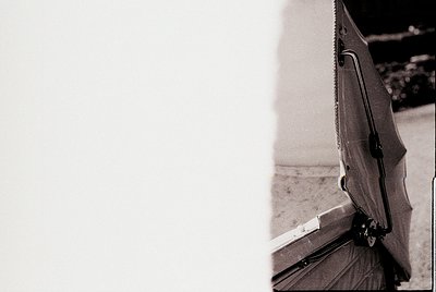 Close-up of a vintage **guitar pickguard** with a **black plastic or resin finish**, featuring a **screw-on mounting system**...